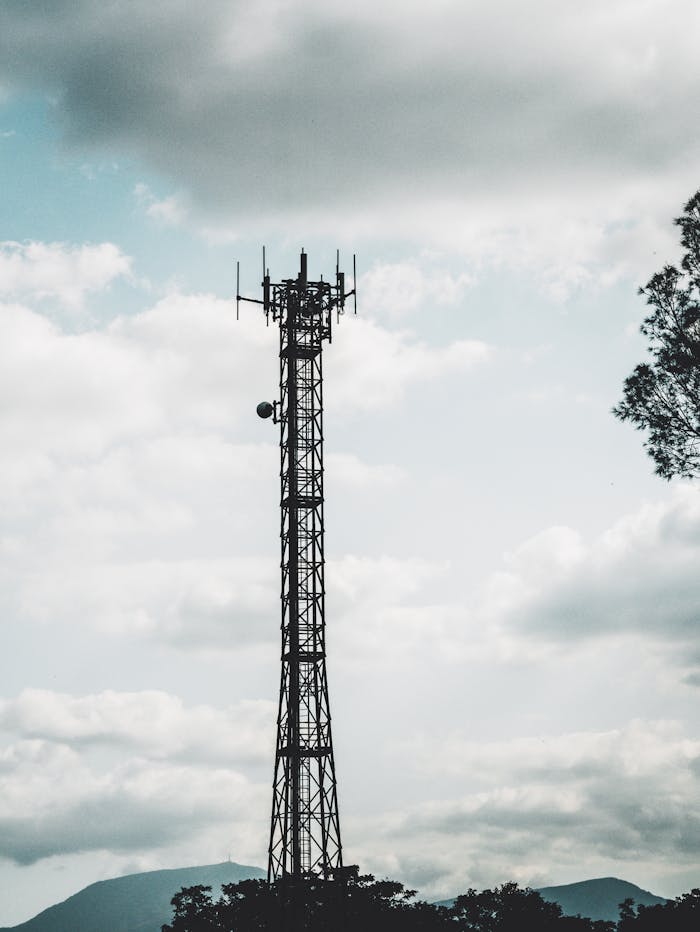 gallery-06 Communication tower in Italy under a cloudy sky, ideal for tech themes.
